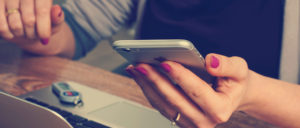 hand of a woman holding an iphone trying to call