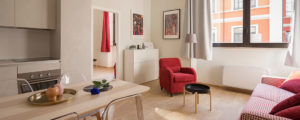 red armchair and coffee table in a clean, bright, well ventilated living room