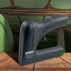 stapler on a wooden table with polyester roll on the back
