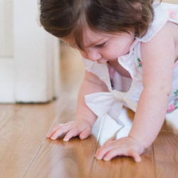 a toddler crawling on timber floors