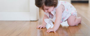 a toddler crawling on timber floors