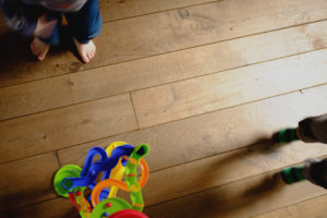 flatlay shot of 2 boys playing their toy on the floor